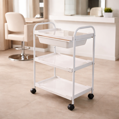 White rolling cart with three shelves in a room setting.