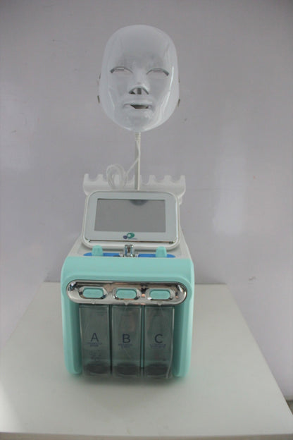 Turquoise electronic device with a face mask on a white background