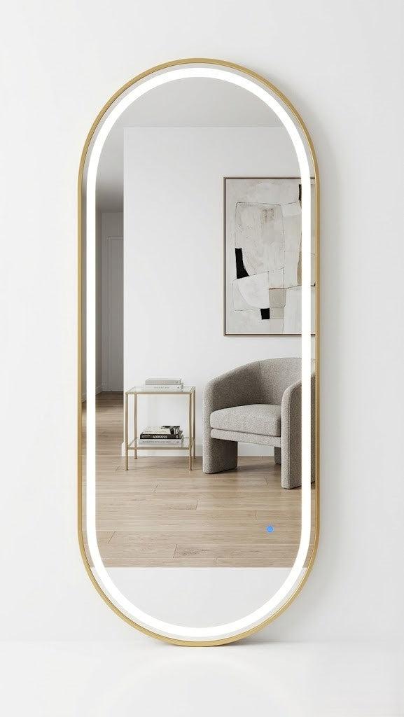 Elongated mirror with gold frame reflecting a room with a chair and table.